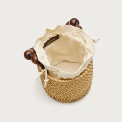 Handknotted rattan bucket bag with wood beads
